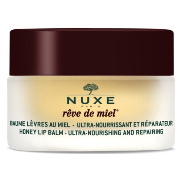 Nuxe Rêve de Miel Lippenbalsam in einem runden, weißen Tiegel mit braunem Deckel und grüner Schrift.