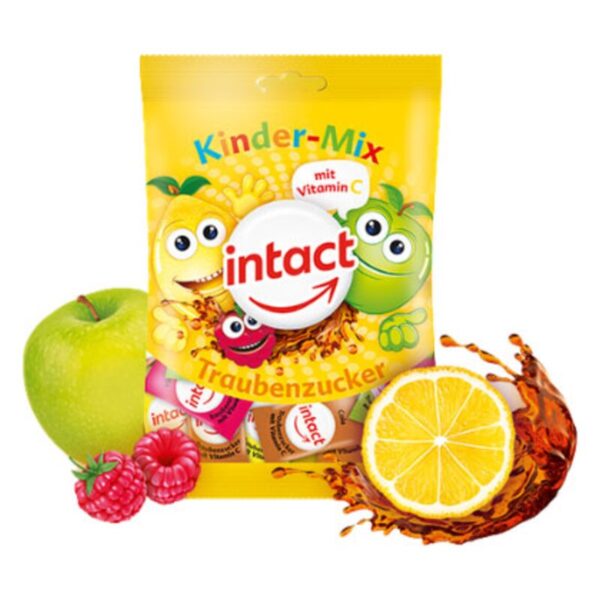 Verpackung für Traubenzucker im Kinder-Mix, umgeben von einem grünen Apfel, Himbeeren und einer halben Zitrone.