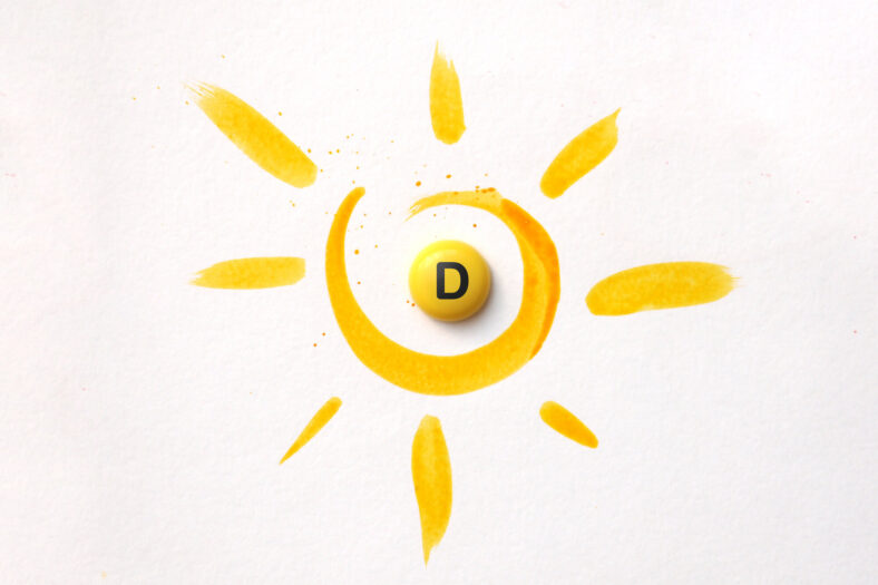 vitamind-sonne.jpg Gelbe Malerei eines Sonnenmotivs mit einer runden, gelben Pille mit dem Buchstaben D in der Mitte.